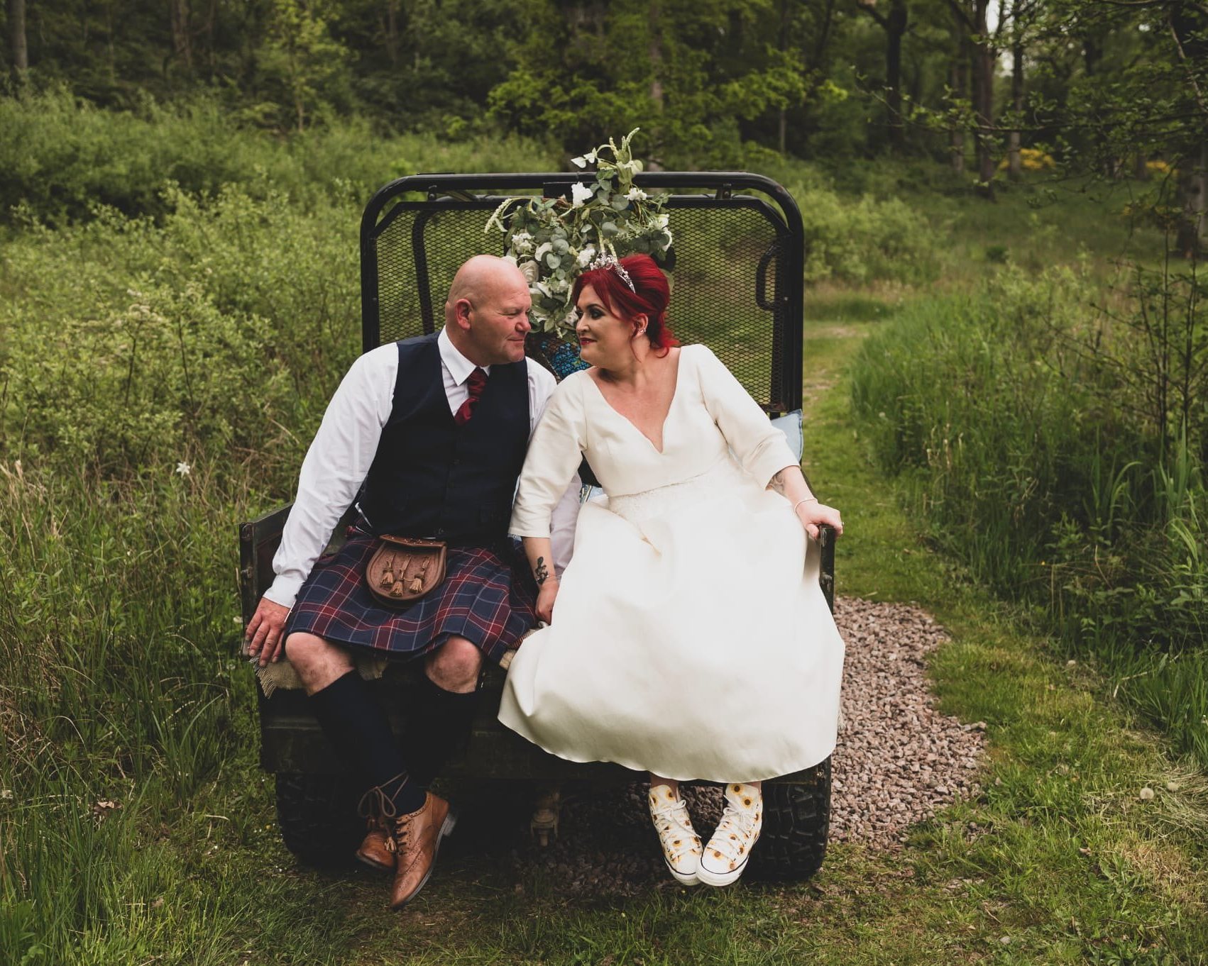 A couple sitting together after their ceremony in Scottish woodland